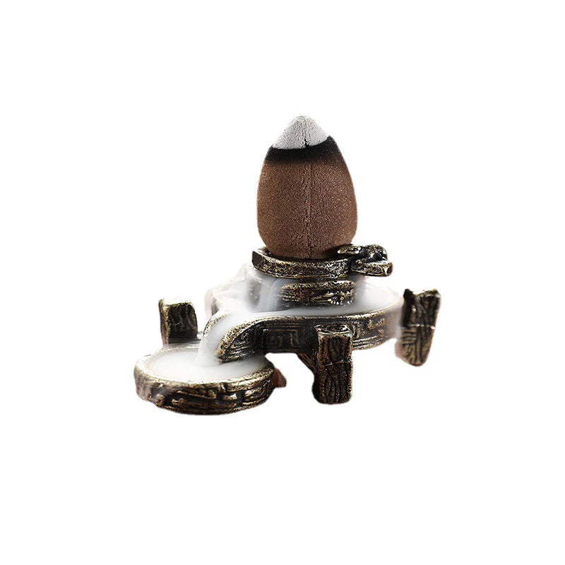 Backflow incense stand with incense cone on dark bronze burner and side tray