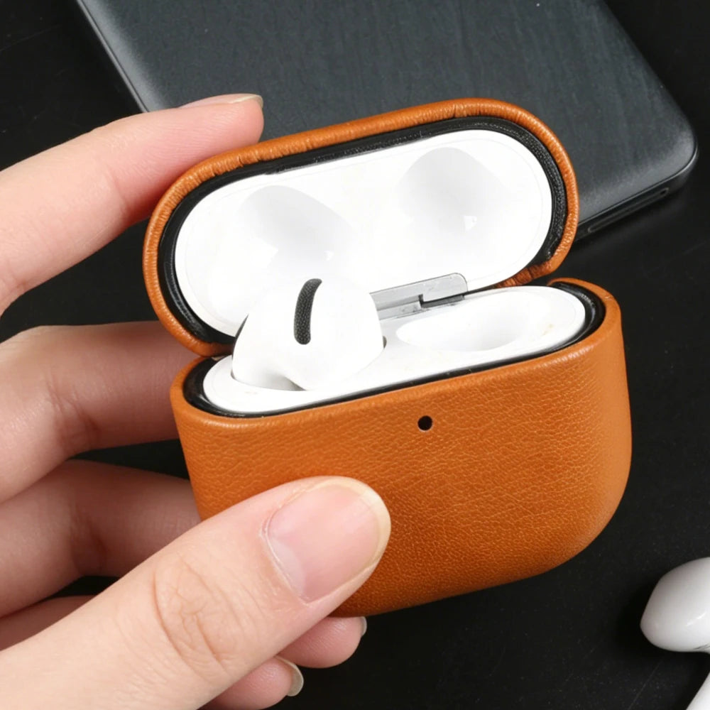 Warm brown eco leather AirPods case with earbuds inside, open lid and orange rim