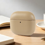 Khaki/beige eco-leather AirPods case, rounded clamshell with small front hole