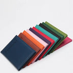 Classic travel passport sleeves, assorted colors, stacked together
