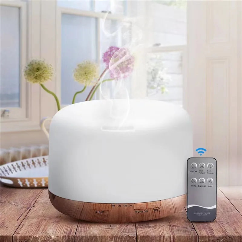 White aroma diffuser humidifier with dark wood base and a hand remote controller