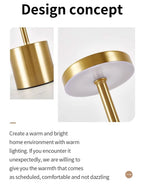 Gold table lamp design close-up with round top cap and cylindrical base
