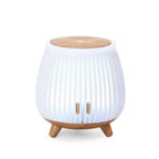 Mini ultrasonic aroma diffuser humidifier with light wood top, white ribbed body, cool blue glow