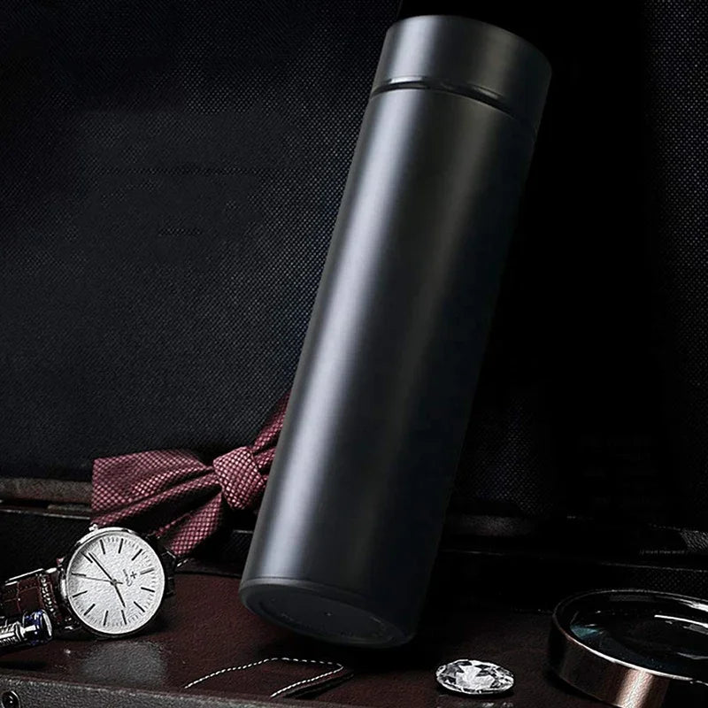 Silver dual-wall smart thermos with side LED base, angled on a surface