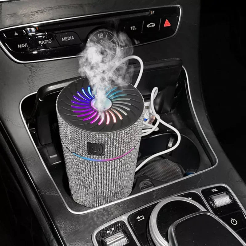 Silver glitter car aroma diffuser with rainbow-lit fan top and vapor cloud