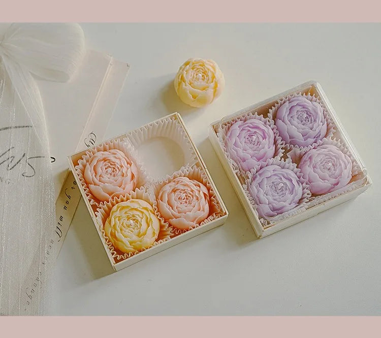 Scented candle gift box with peach and lilac rose-shaped candles in a divided tray