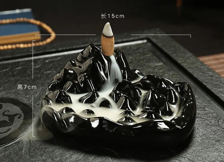 Black glossy backflow incense burner tray with miniature hand and conical incense