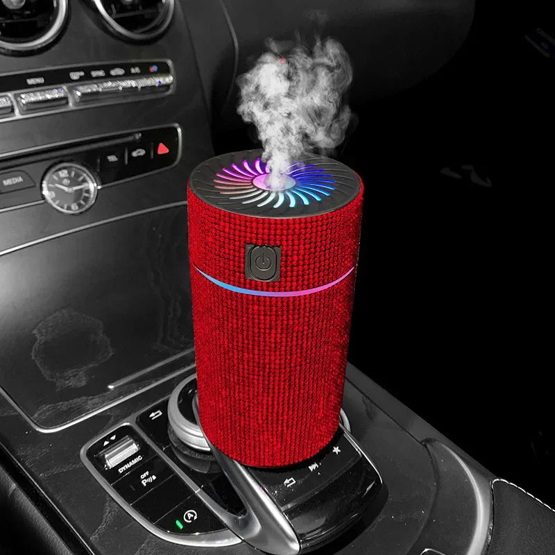 Red glitter car aroma diffuser on dashboard with blue light ring and vapor