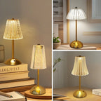 Cordless night lamp with gold brass base and white pleated acrylic shade