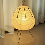 Bedside paper artisan lamp with teardrop shade, black constellation pattern, on tripod legs
