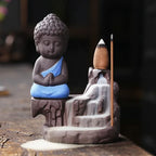 Backflow incense burner front view, blue-robed Buddha with incense cone
