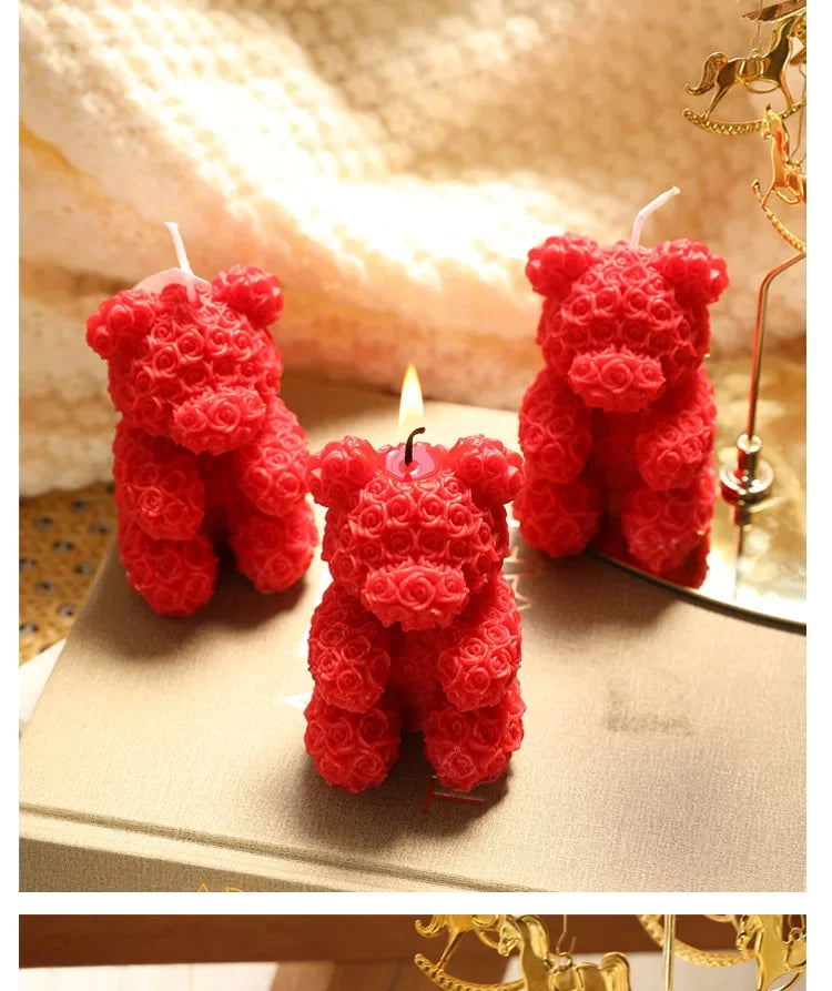 Rose bear scented candle set: three red rose bear candles, one with a lit wick