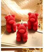 Rose bear scented candle set: three red rose bear candles, one with a lit wick