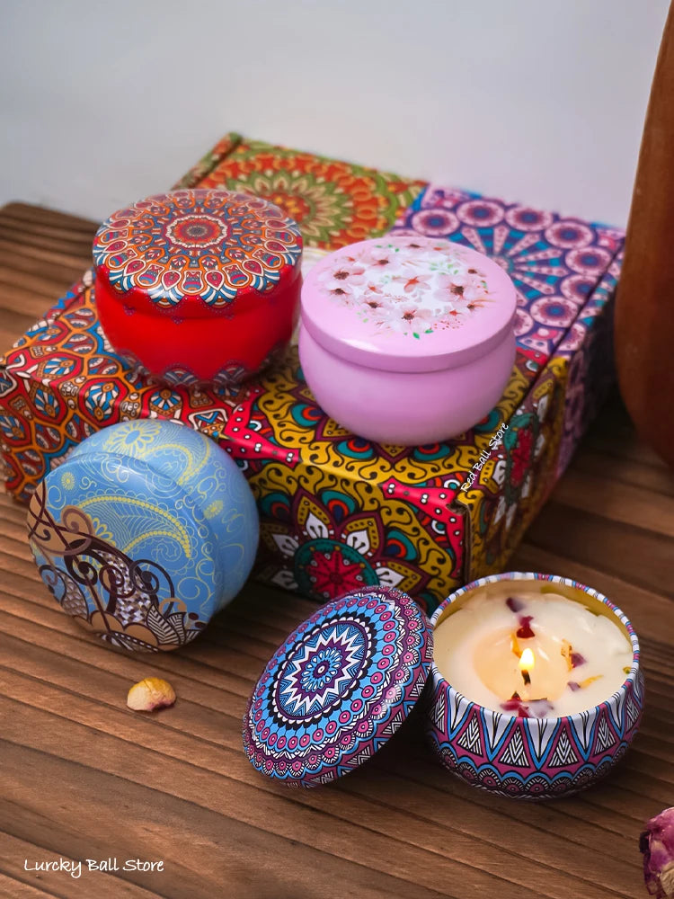Assorted scented candle tins with Arabian pattern lids, including one lit blue tin