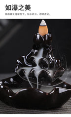 Glazed black backflow incense tower burner with cone incense and dense smoke plume
