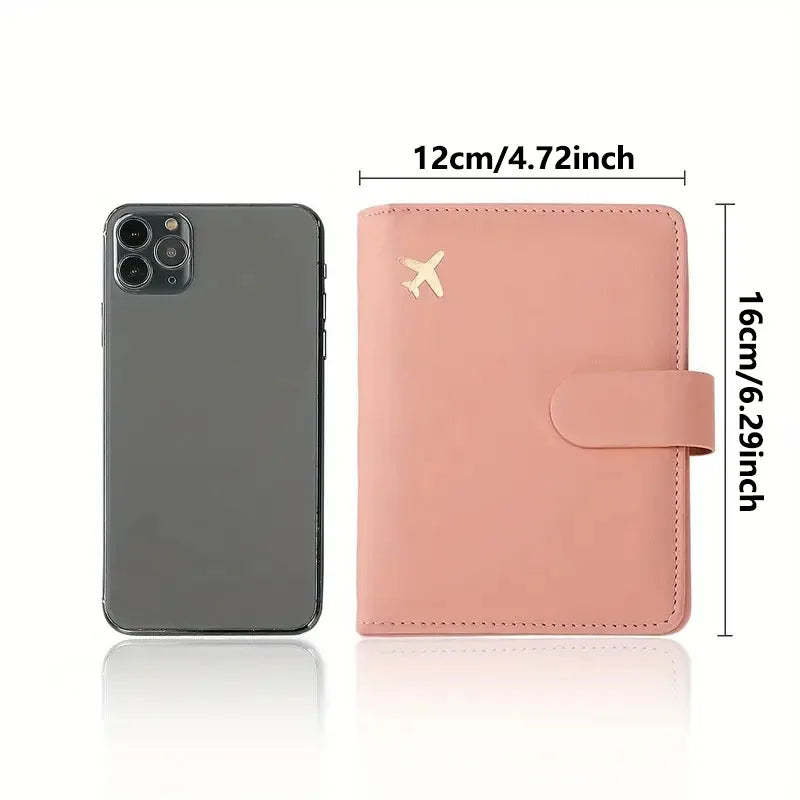 Blush pink passport folio with airplane emblem and side strap, single front view