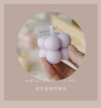 Purple bubble candle cluster held in hand, with “BUBBLE CANDLES” label