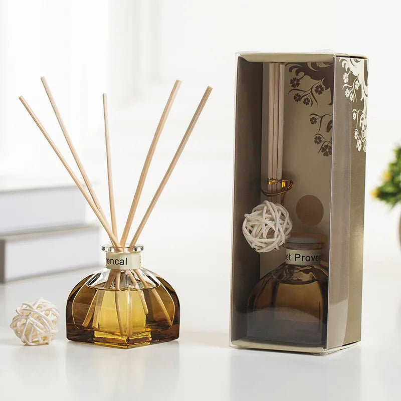 Reed diffuser bottle with light wooden reeds and white woven ball, in gift box