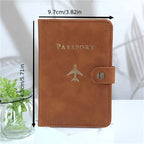 Cognac brown vegan leather passport holder with “PASSPORT” text and airplane emblem