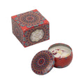 Vintage scented candle jar with red geometric pattern lid and white wax with petals