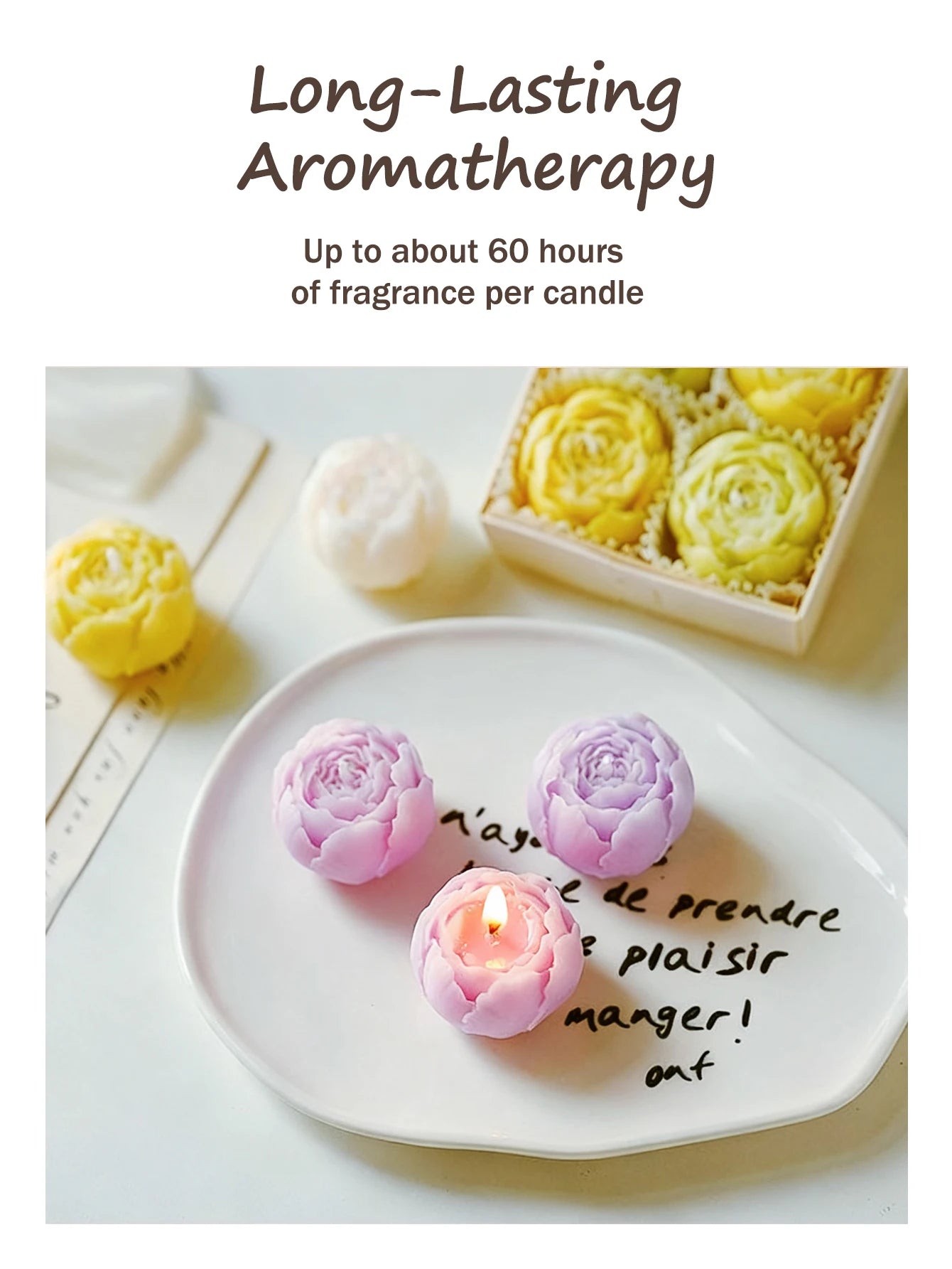 Lavender rose candles on a plate: two purple, one pink candle with a flame