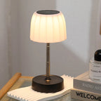 Single warm LED desk lamp with white pleated shade, black base, gold telescopic pole