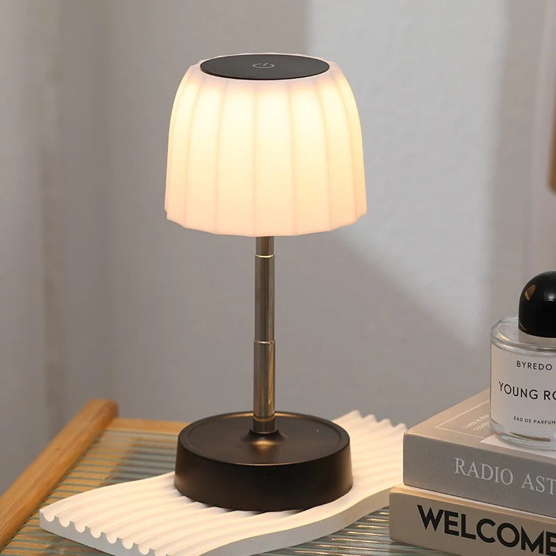 Single warm LED desk lamp with white pleated shade, black base, gold telescopic pole
