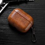 Mocha brown crocodile-grain AirPods case with keyring, top view