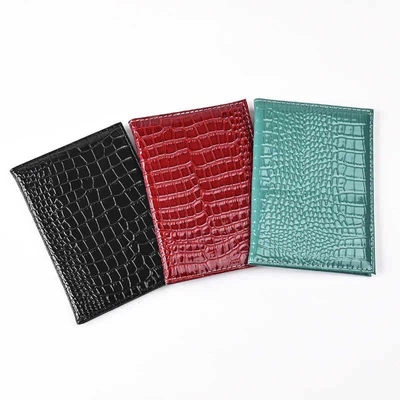 Passport cover trio in Midnight Black, Burgundy, and Forest Green croc texture
