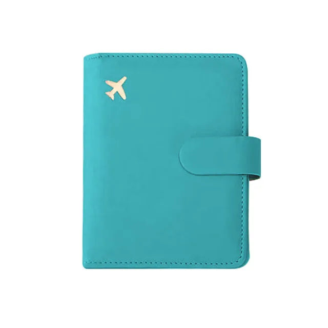 Teal passport folio with gold airplane emblem and wrap-around strap closure