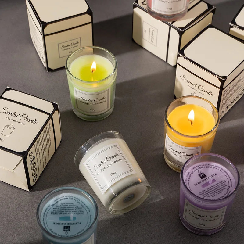 Scented candle gift box assortment with several glass candles and matching boxes.