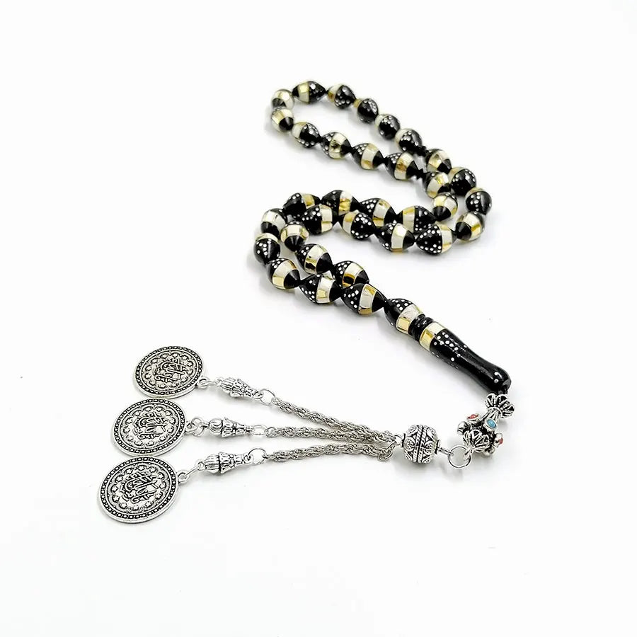 Tasbih bracelet with black and gold striped beads and three silver medallion charms