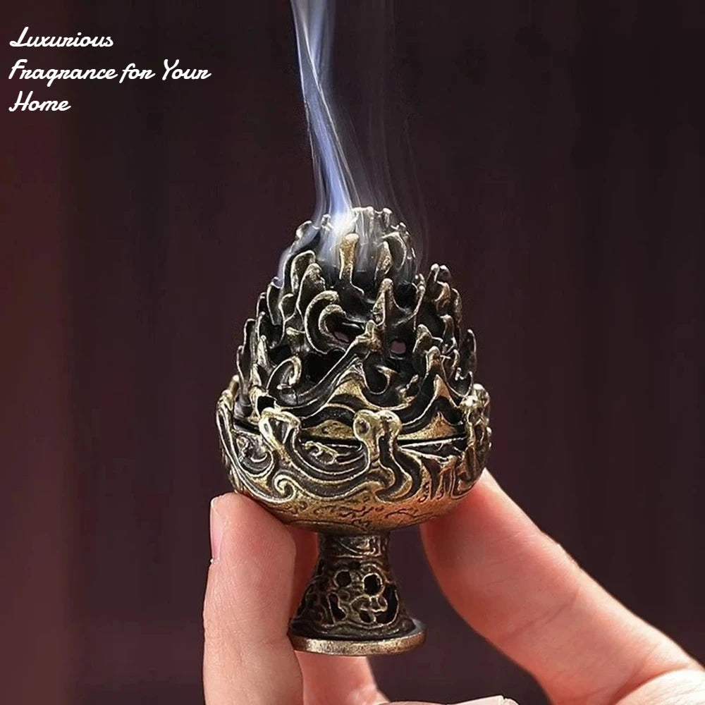 Copper-toned incense censer with carved flame-lotus design and rising incense smoke.