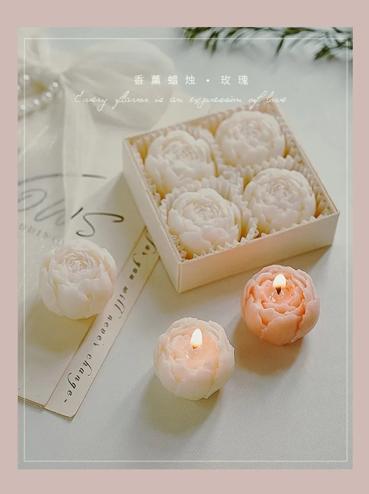 Rose-scented candle gift box with ivory rose-shaped candles and two lit candles