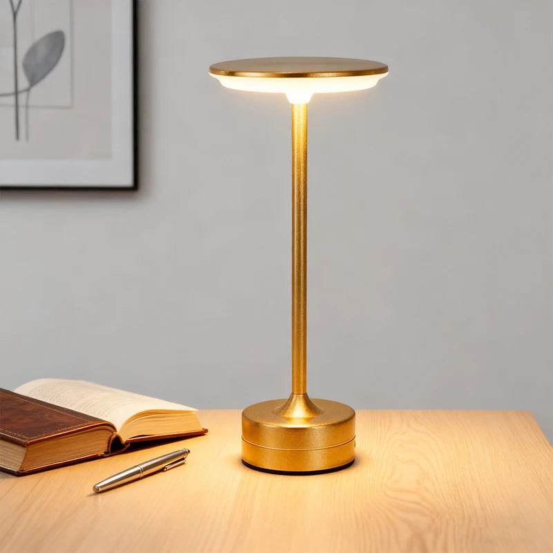 Cordless touch reading lamp with round top and cylindrical base, gold finish
