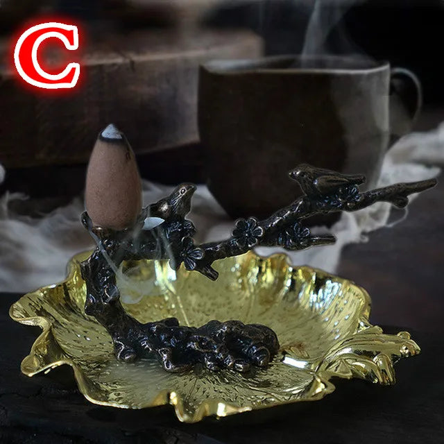 Plum branch incense stand with cone incense, leaf basin and dark bird-like details