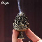 Bronze mountain incense burner on pedestal, held in a hand