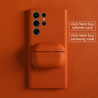 Orange leather AirPods snap case, closed with top seam and small dot detail