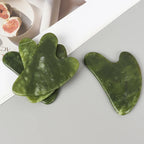 Heart-shaped jade gua sha massager, green Xiuyan jade with cutout handle notch