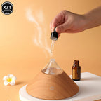 Wood grain compact aroma diffuser with glass top, mist stream and glowing power icon