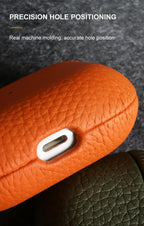 Orange cowhide AirPods case with precise bottom cutout and pebbled grain