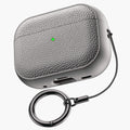 Gray leather-pattern AirPods case with keychain ring attached