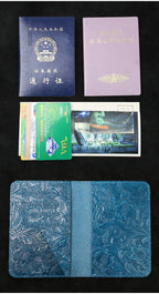 Blue leather travel folio with card slots, passport and ID cards laid on it