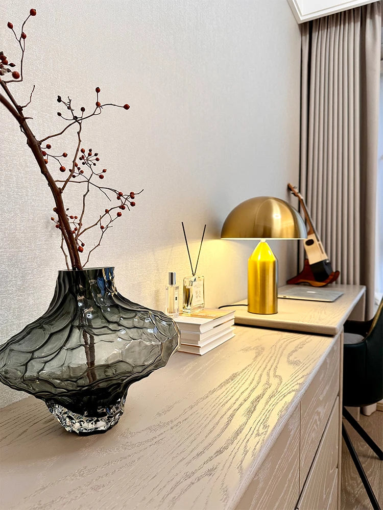Gold mushroom LED table lamp on side table, dome shade glowing softly