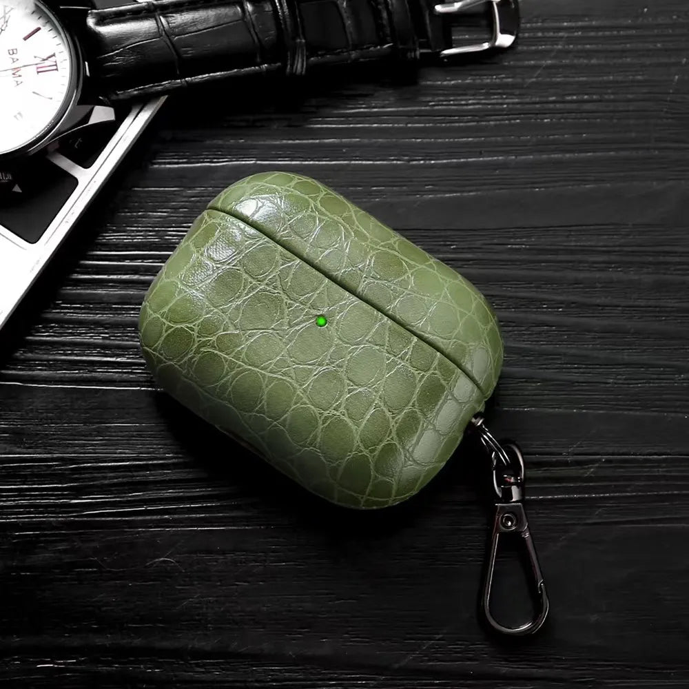 Olive green crocodile-grain AirPods case with keyring, front view