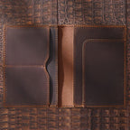 Brown passport wallet interior with two card pockets, center spine panel, and right slip holder