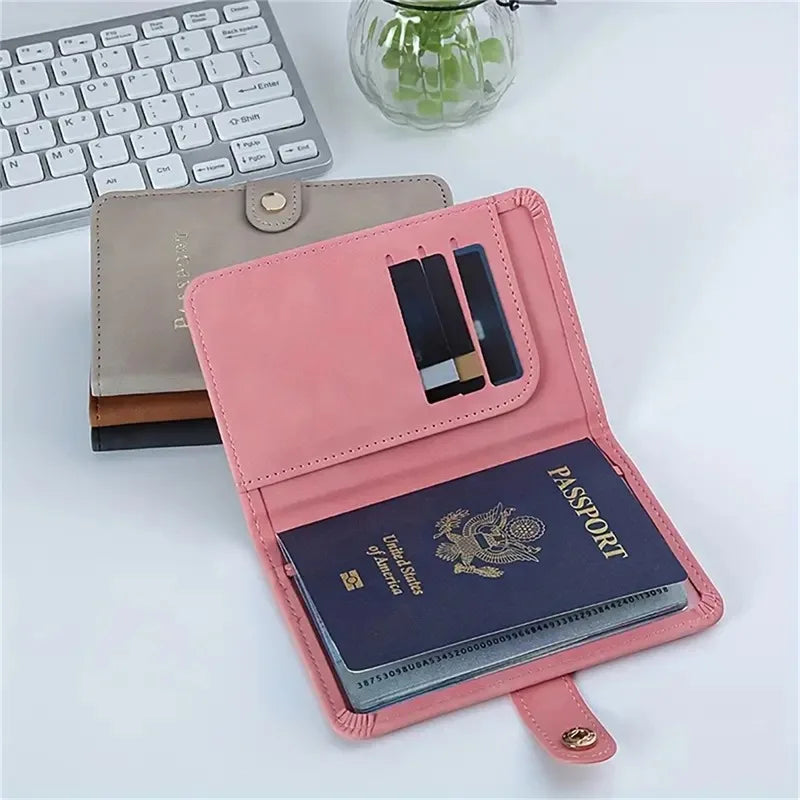 Blush pink passport holder open, showing ID slot and “PASSPORT” booklet in dark blue