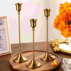 Gold metal tabletop candle holder set with three tall candlestick stands