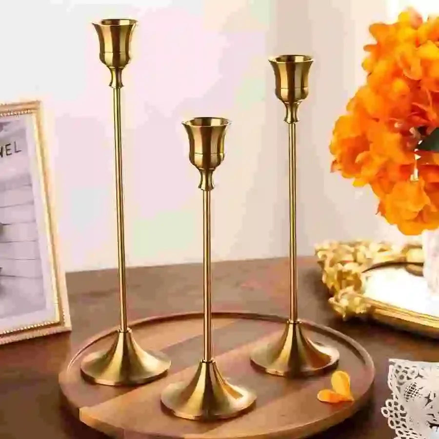 Gold metal tabletop candle holder set with three tall candlestick stands