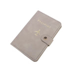 Slate grey passport cover with airplane emblem, “PASSPORT” text, and side snap closure